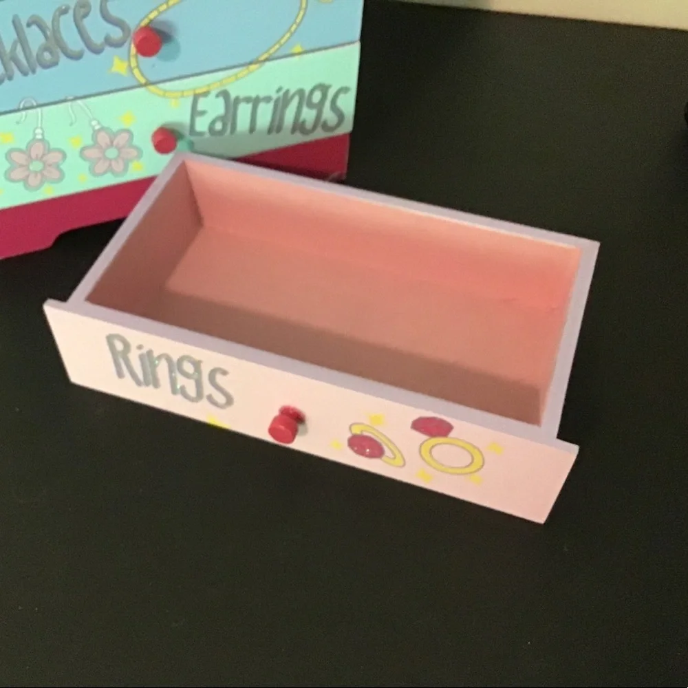 Children’s wood four drawer jewelry chest.